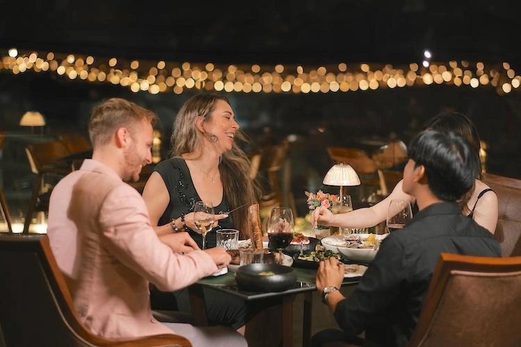 A group of people at an ocean view restaurant in Sanur
