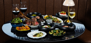 A spread food and beverages from a steakhouse